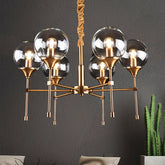Vintage Brass Burst Suspension Lamp - Clear Glass Chandelier for Dining Table - 6 Head Design - This ceiling light is a brass burst style suspension lamp with retro appeal. It has six heads with clear glass shades that face upward. The light is a...